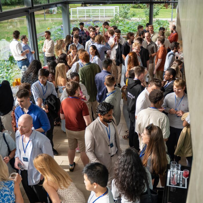 A crowded networking event with diverse attendees.