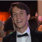 Smiling person in formal attire at an event.