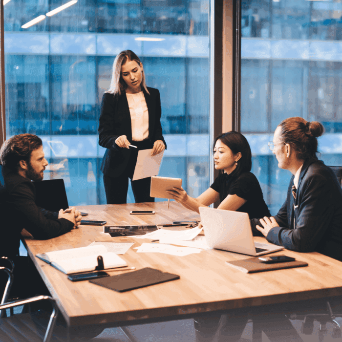 Business meeting with four professionals discussing ideas.