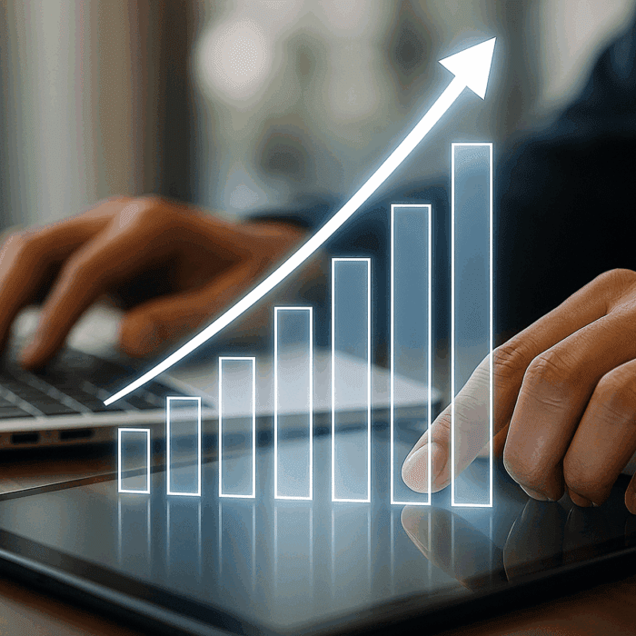 Hands interacting with a tablet, displaying a rising graph with bars and an arrow.