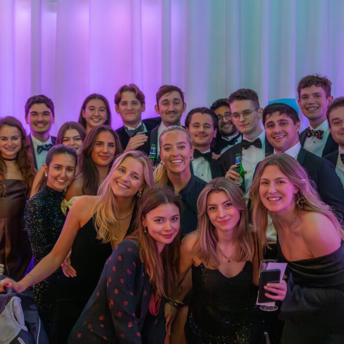 Group of young adults posing together at a celebration.