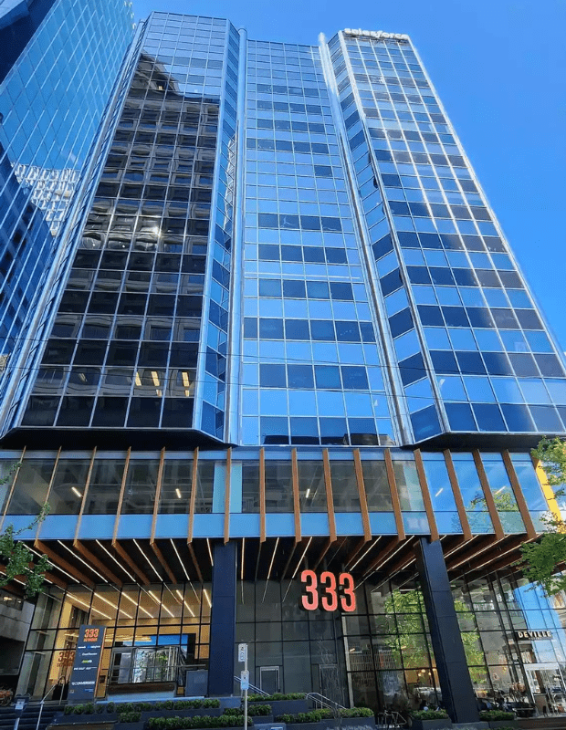 Modern glass building with large entrance at 333.